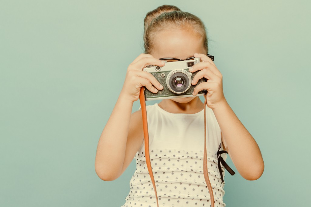 smiling child  holding a  camera