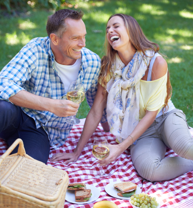 Shot of a married couple enjoying a picnic outdoors